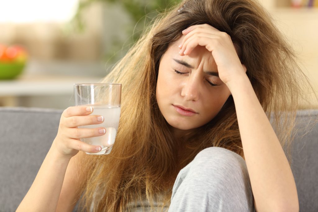 woman has a headache and general discomfort during opiate withdrawal