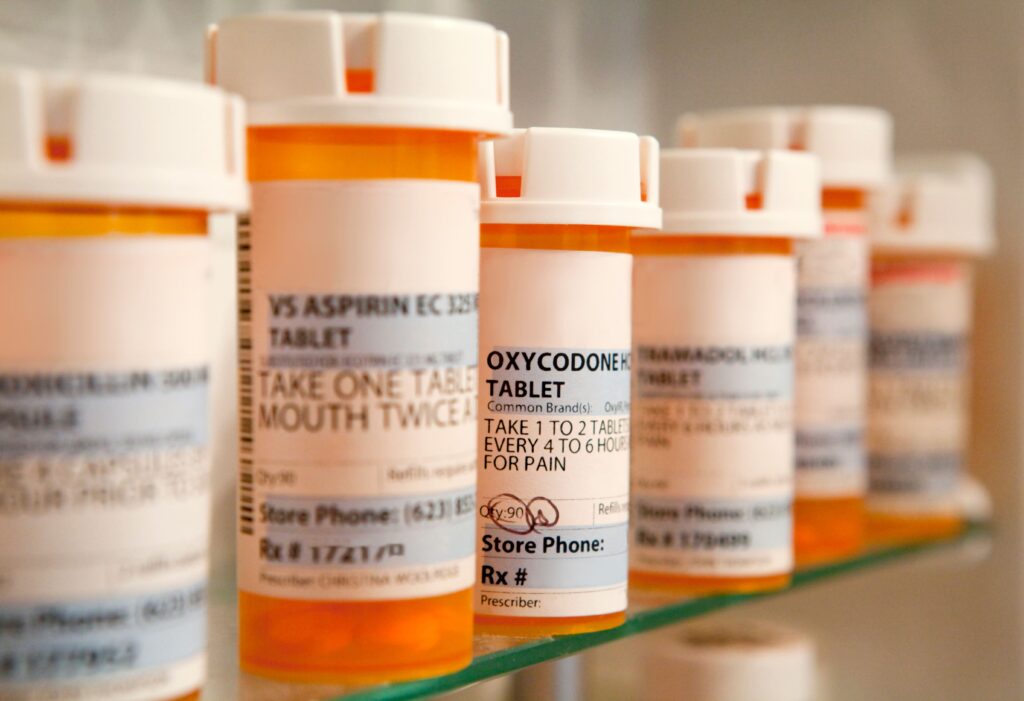 prescription medications on a glass shelf